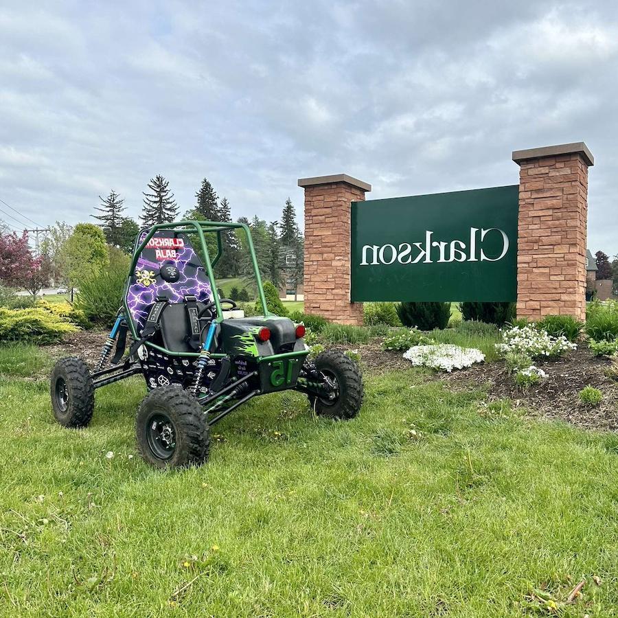 Baja SAE car out on the lawn next to the Clarkson sign